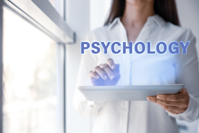 Image of Psychologist working with modern tablet in office, closeup 