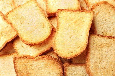 Toasted slices of bread as background, closeup