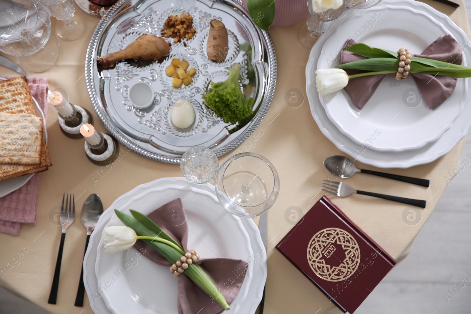 Photo of Festive Passover table setting with Torah, top view. Pesach celebration