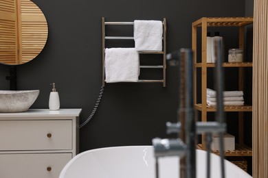 Photo of Stylish bathroom interior with heated towel rail and modern furniture