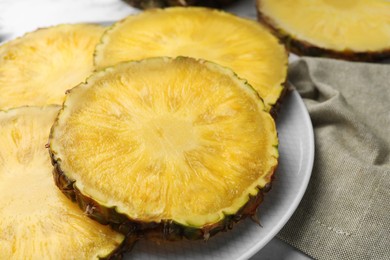 Photo of Slices of tasty ripe pineapple on table, closeup