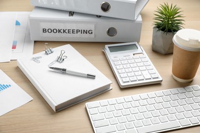 Bookkeeper's workplace with folders and documents on table