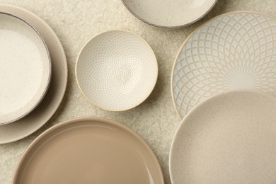 Photo of Beautiful ceramic plates and bowls on table, flat lay