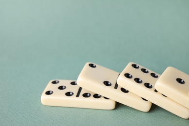 Photo of Classic domino tiles on grey background, closeup. Space for text