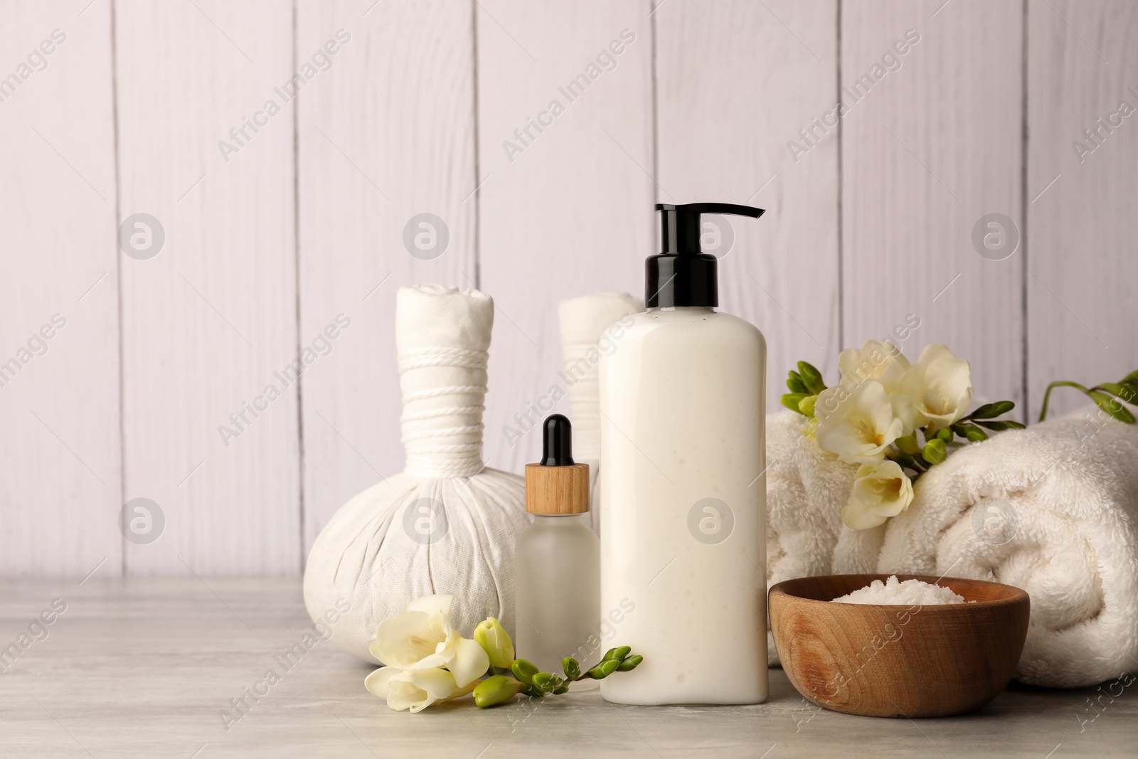 Photo of Beautiful composition with different spa products on light gray table. Space for text