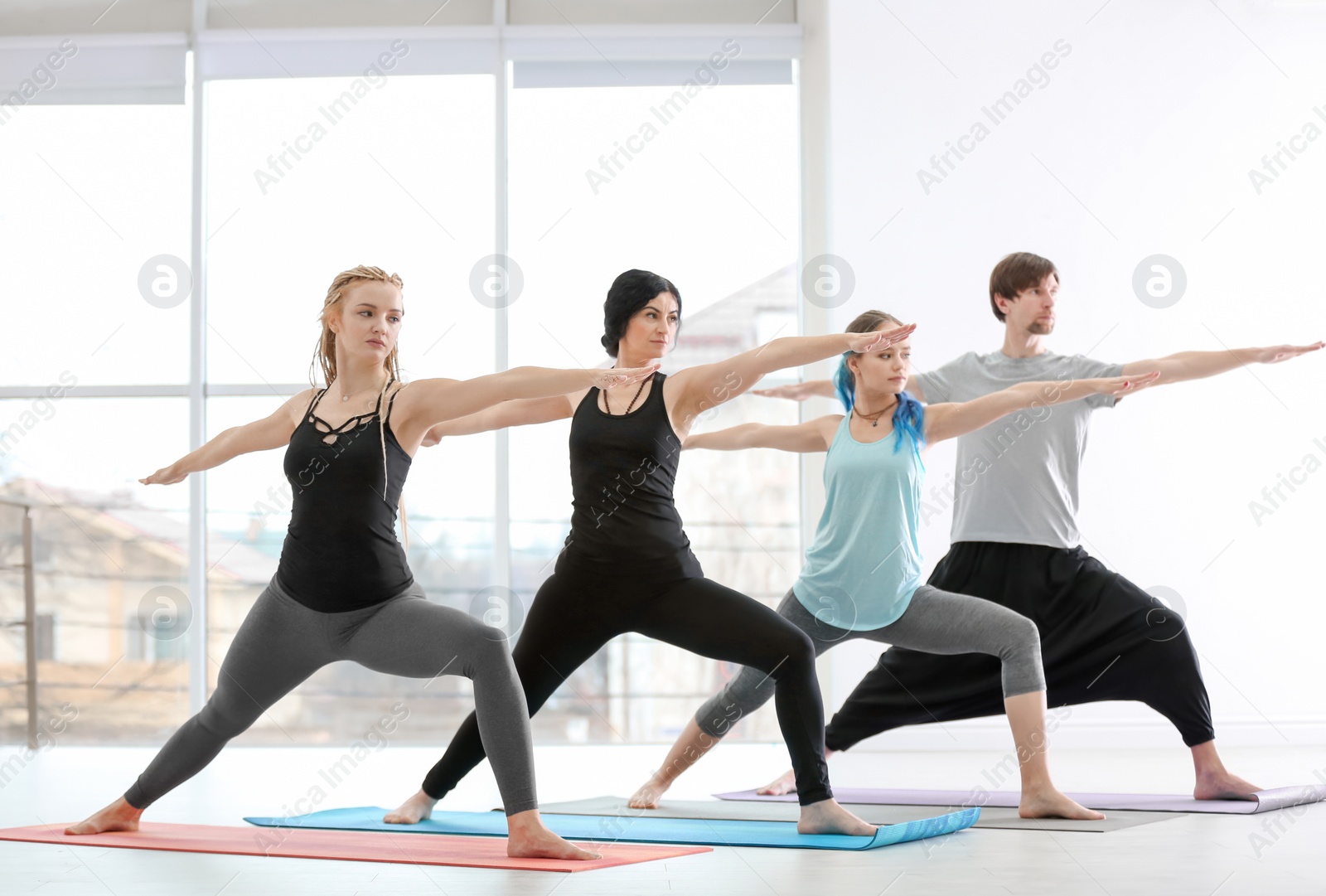 Photo of Group of people practicing yoga indoors