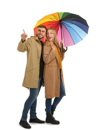 Photo of Full length portrait of beautiful couple with umbrella, isolated on white