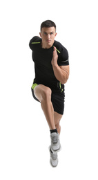 Athletic young man running on white background