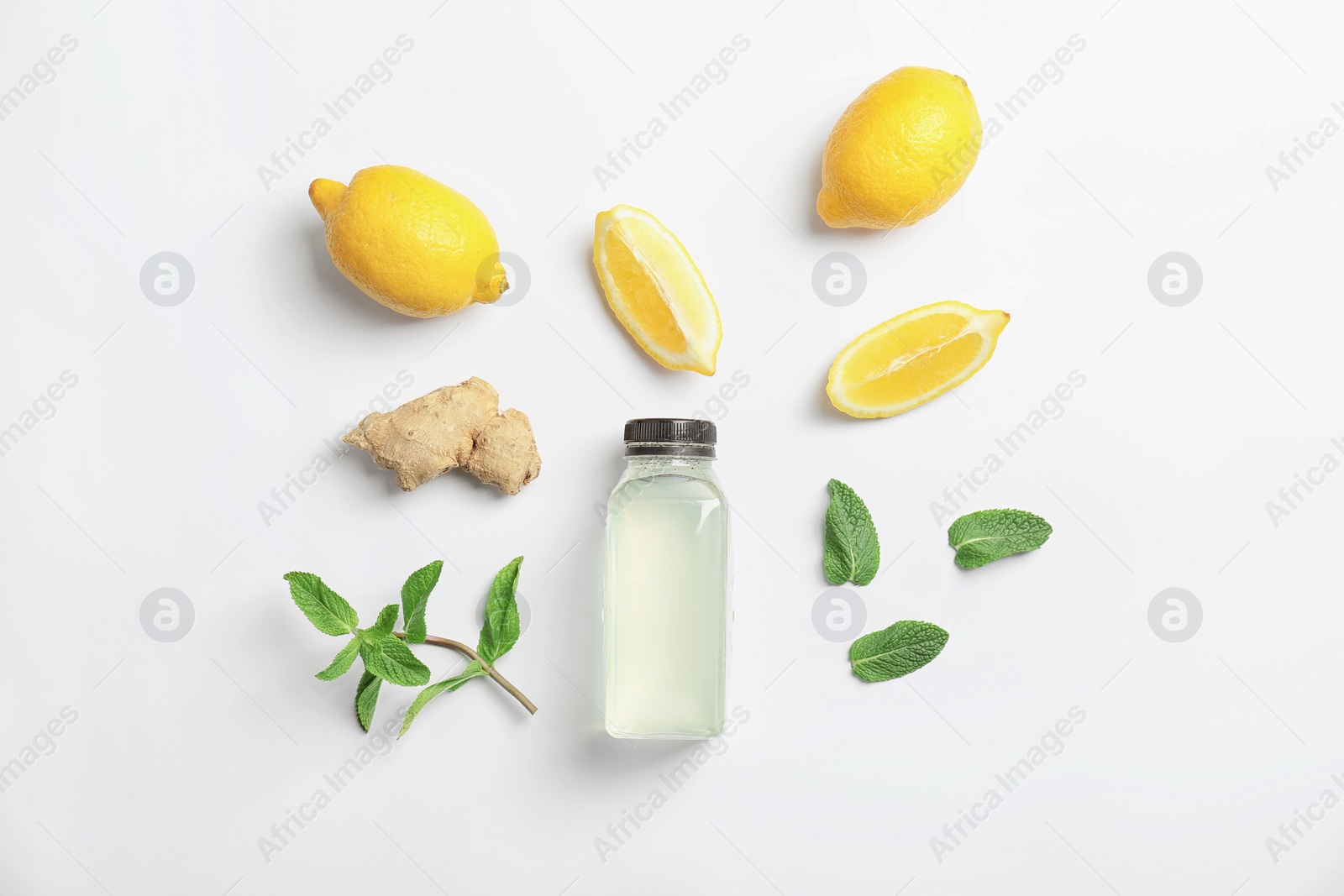 Photo of Flat lay composition with delicious natural lemonade on white background