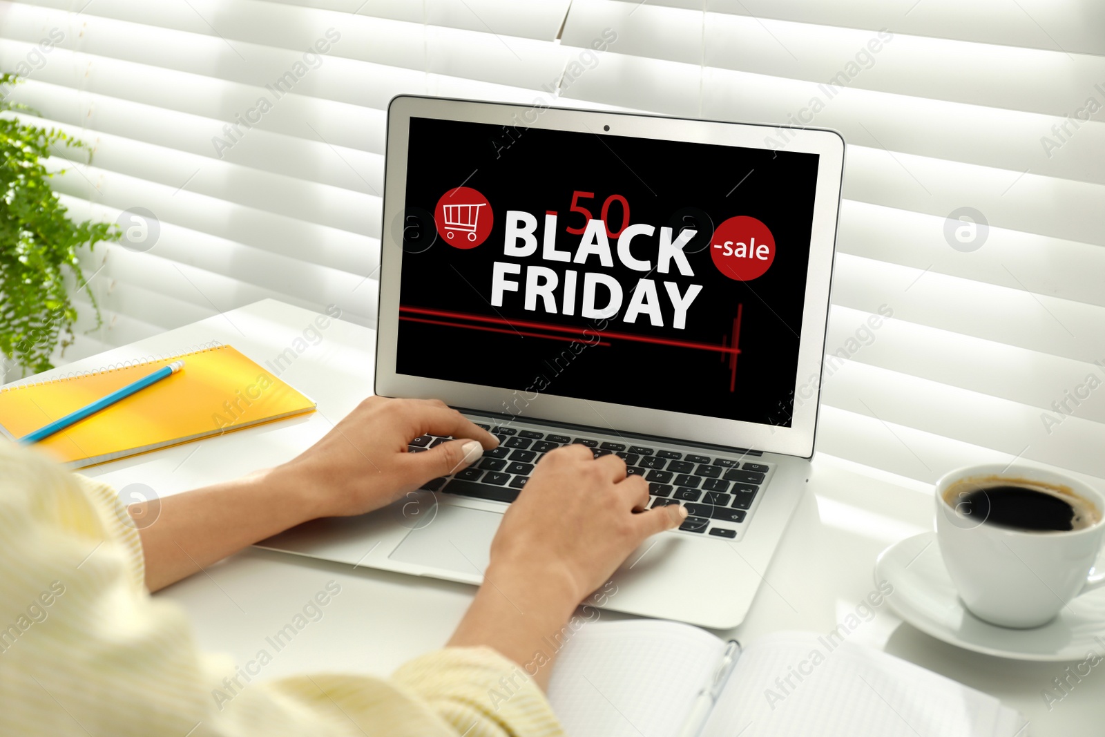 Image of Black Friday. Woman shopping online using laptop at table, closeup