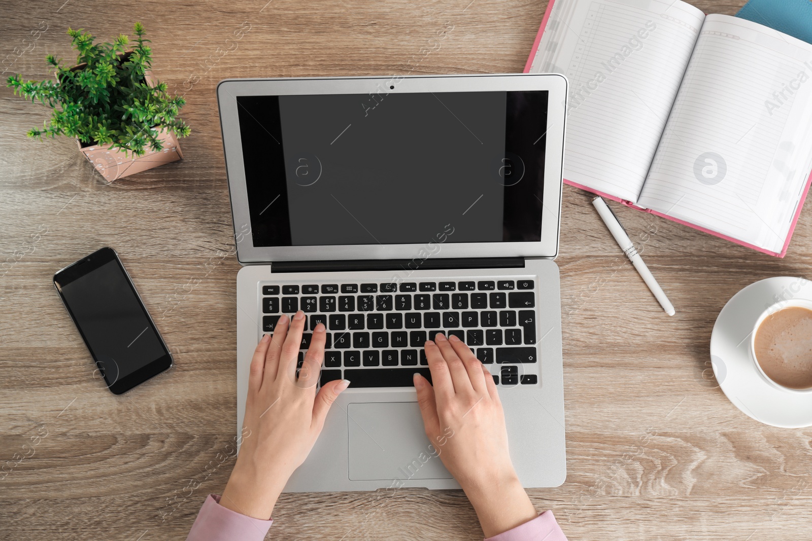 Photo of Woman using laptop at table, top view. Space for design