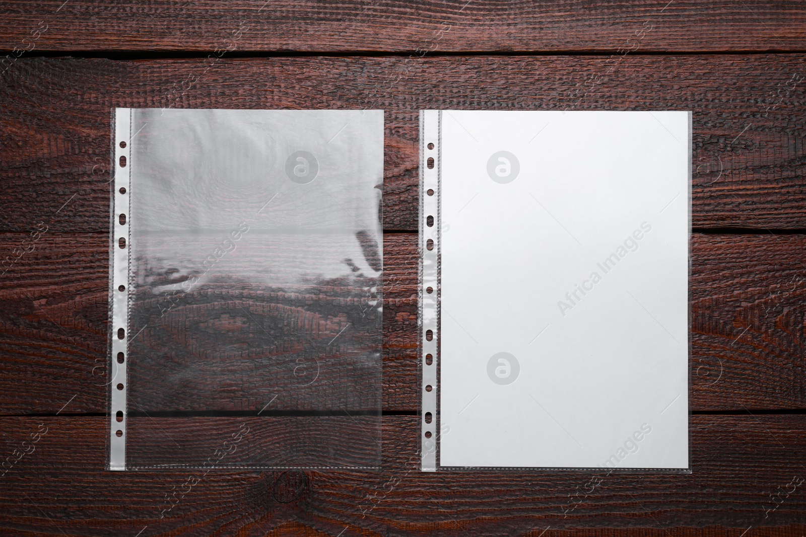 Photo of Punched pockets on wooden table, flat lay