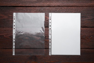 Photo of Punched pockets on wooden table, flat lay