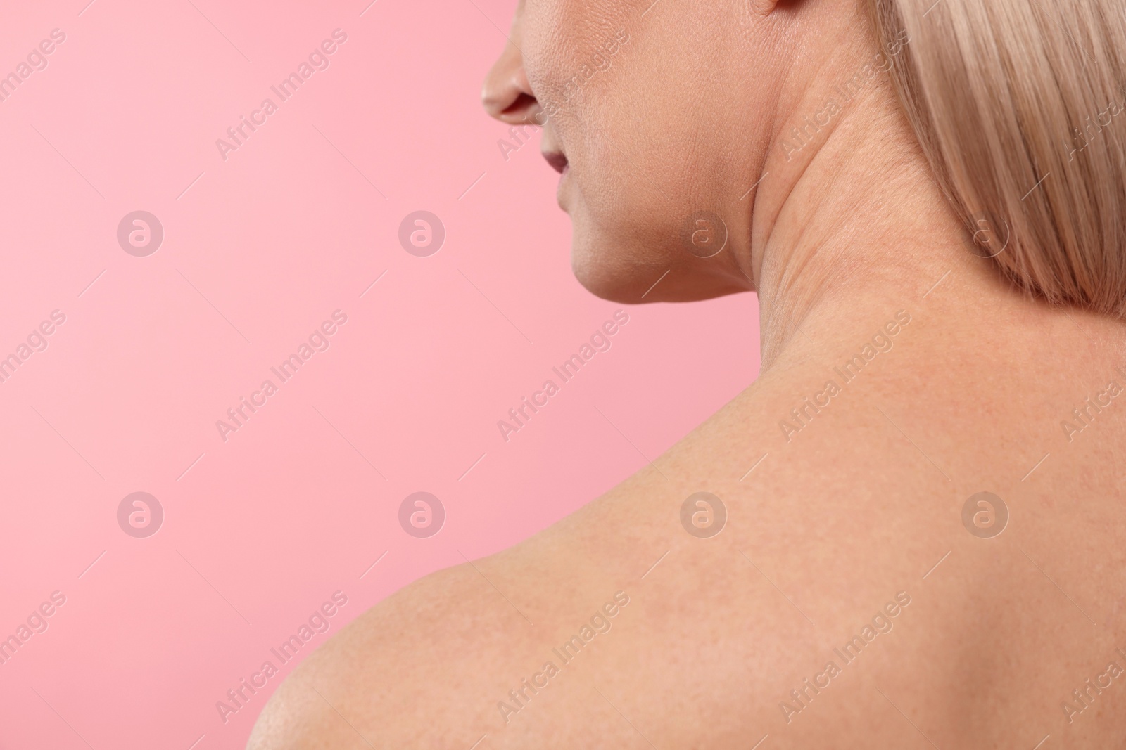 Photo of Woman with healthy skin on pink background, closeup