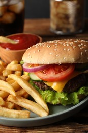 Photo of Delicious burger, soda drink and french fries served on wooden table, closeup