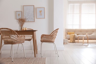 Dining room interior with wooden table and wicker chairs