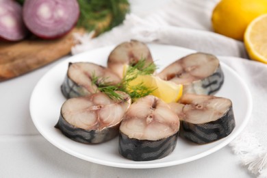 Photo of Slices of tasty salted mackerel on white table, closeup