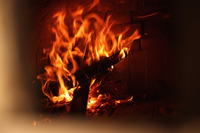 Photo of Oven with burning firewood in restaurant kitchen