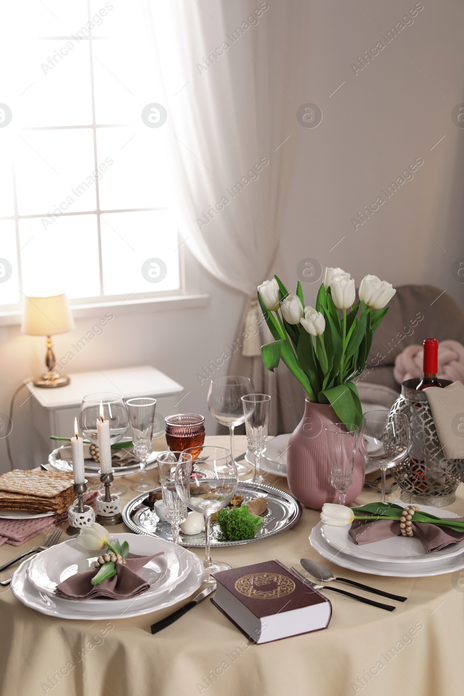 Photo of Festive Passover table setting with Torah at home. Pesach celebration