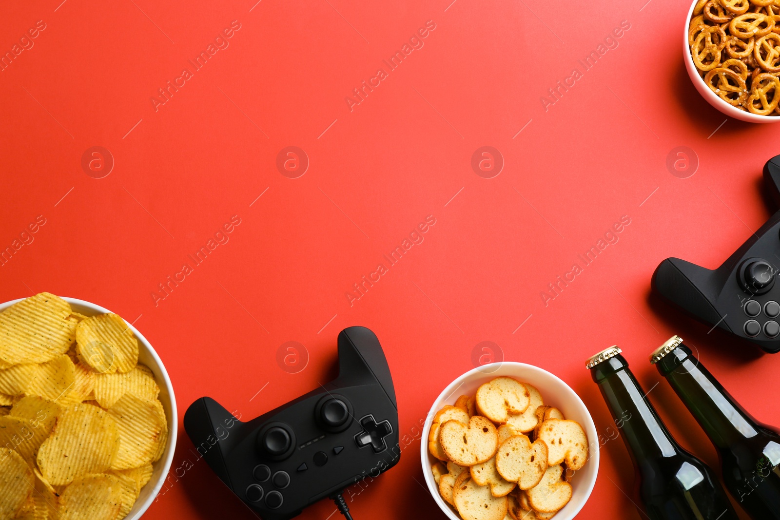 Photo of Flat lay composition with video game controllers, snacks and space for text on color background