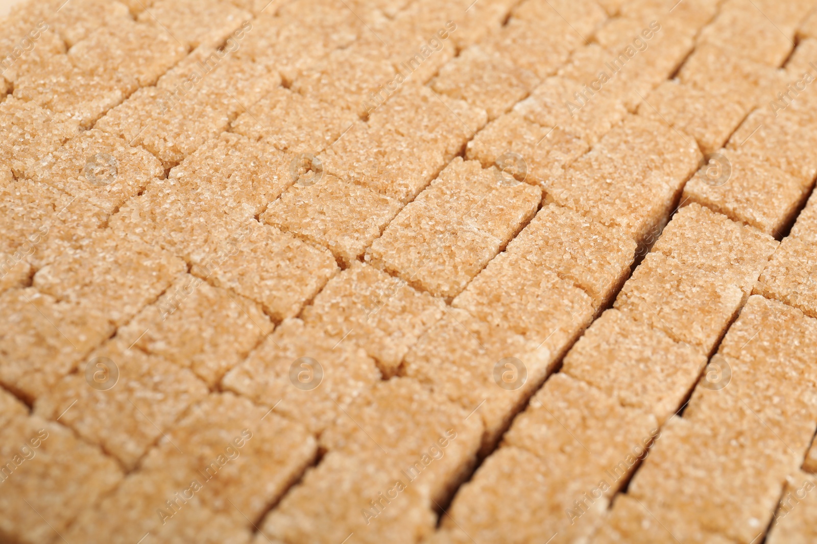 Photo of Brown sugar cubes as background, closeup view