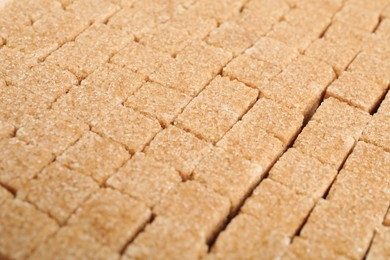 Photo of Brown sugar cubes as background, closeup view