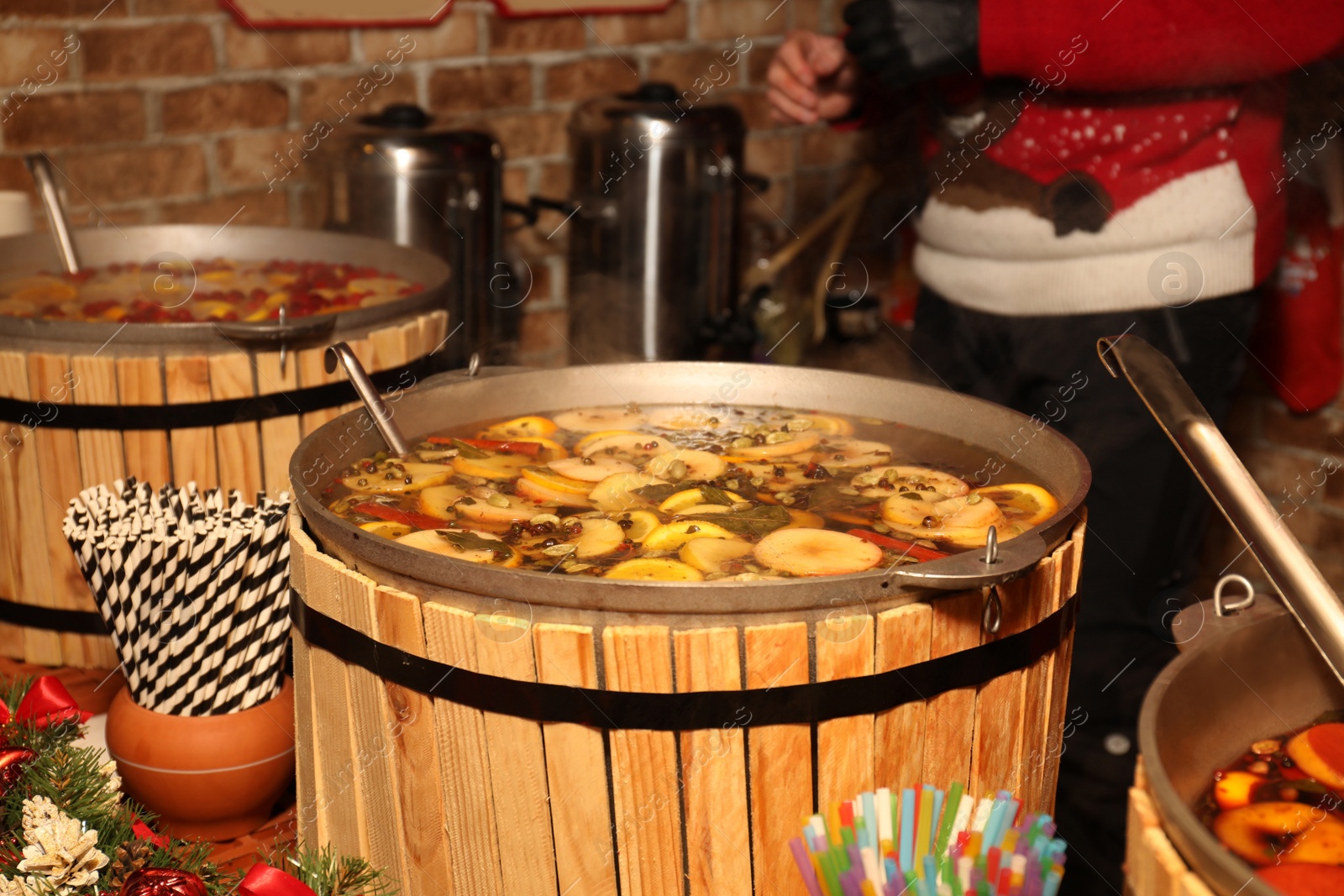 Photo of Large cauldron with tasty mulled wine at winter fair