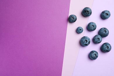 Photo of Flat lay composition with tasty blueberry and space for text on color background