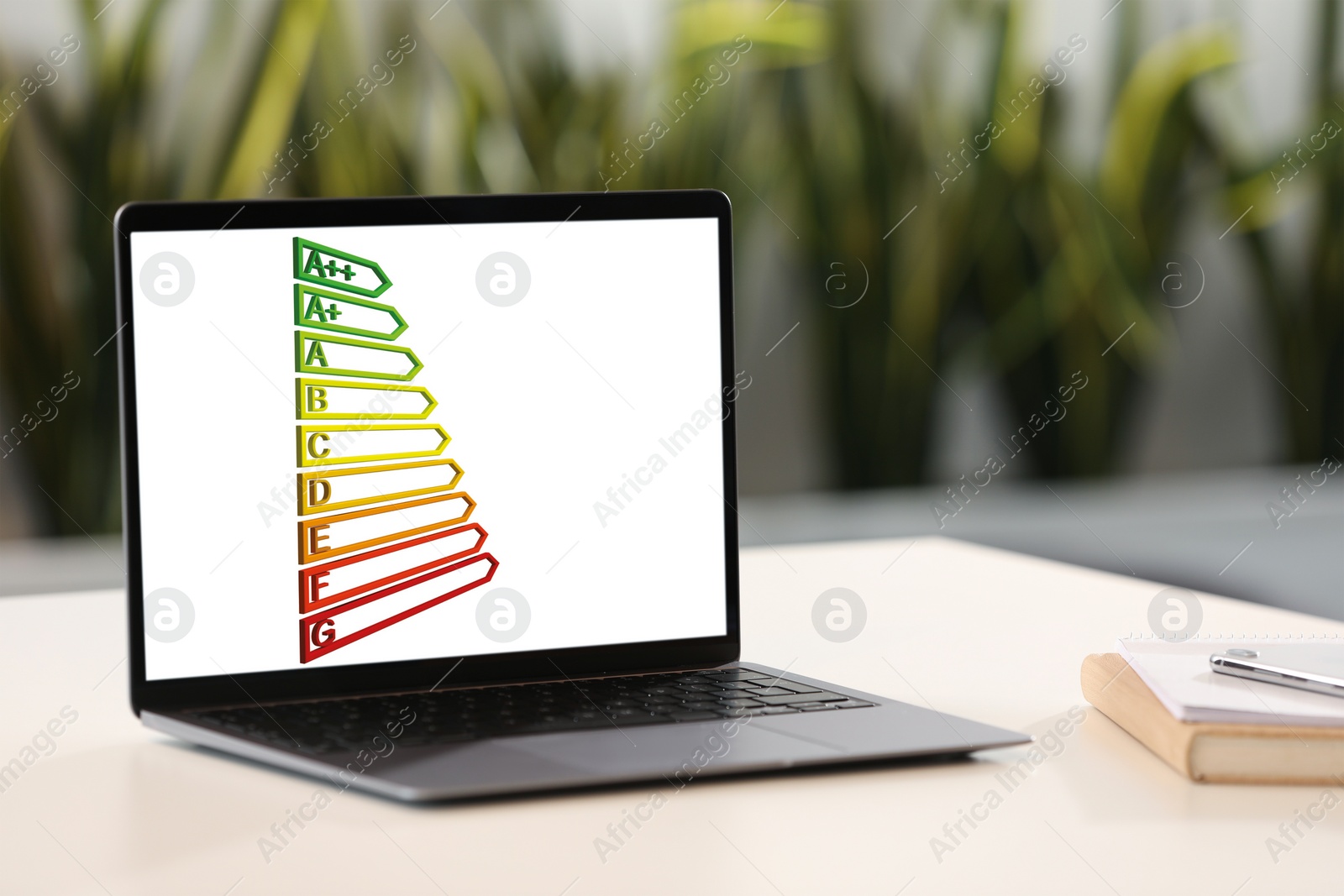 Image of Energy efficiency rating on laptop display. Workplace with modern computer