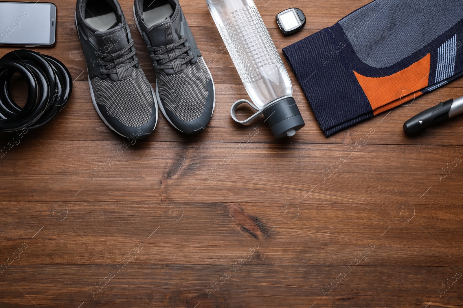 Photo of Flat lay composition with different cycling accessories on wooden background, space for text