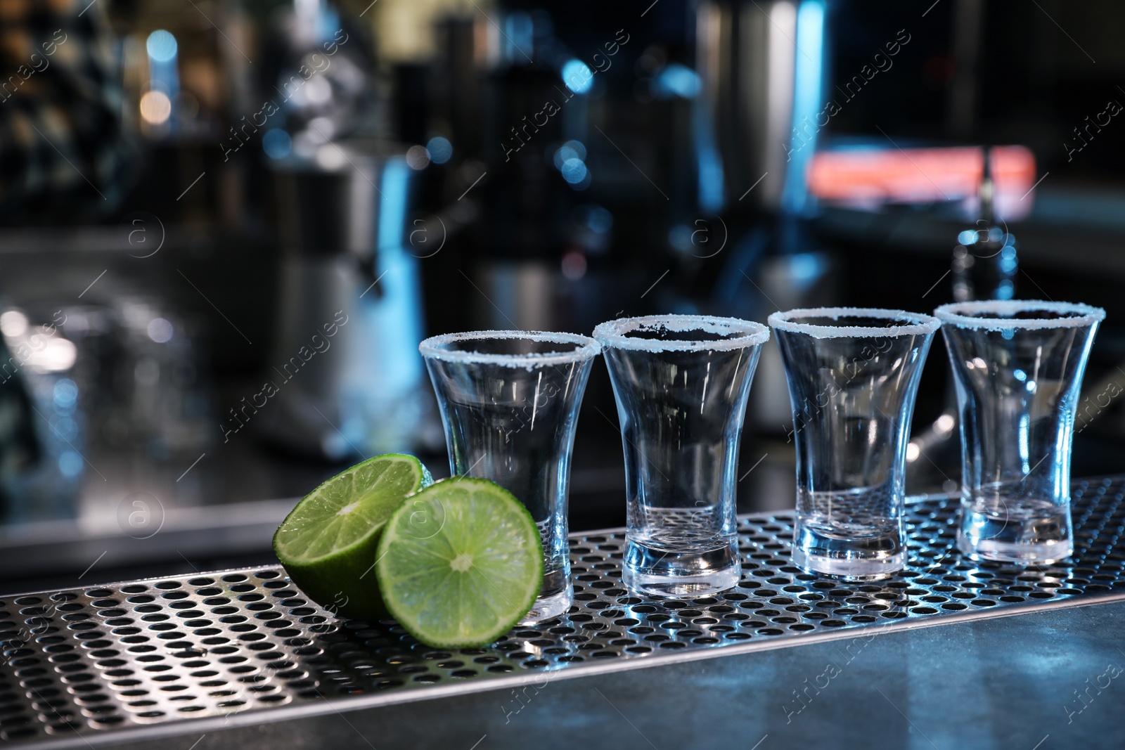Photo of Mexican Tequila shots and lime on bar counter