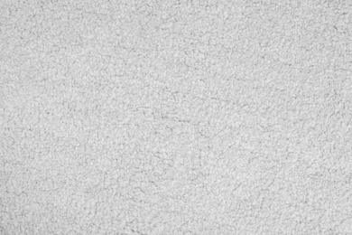 Photo of Light soft carpet as background, top view. Interior element