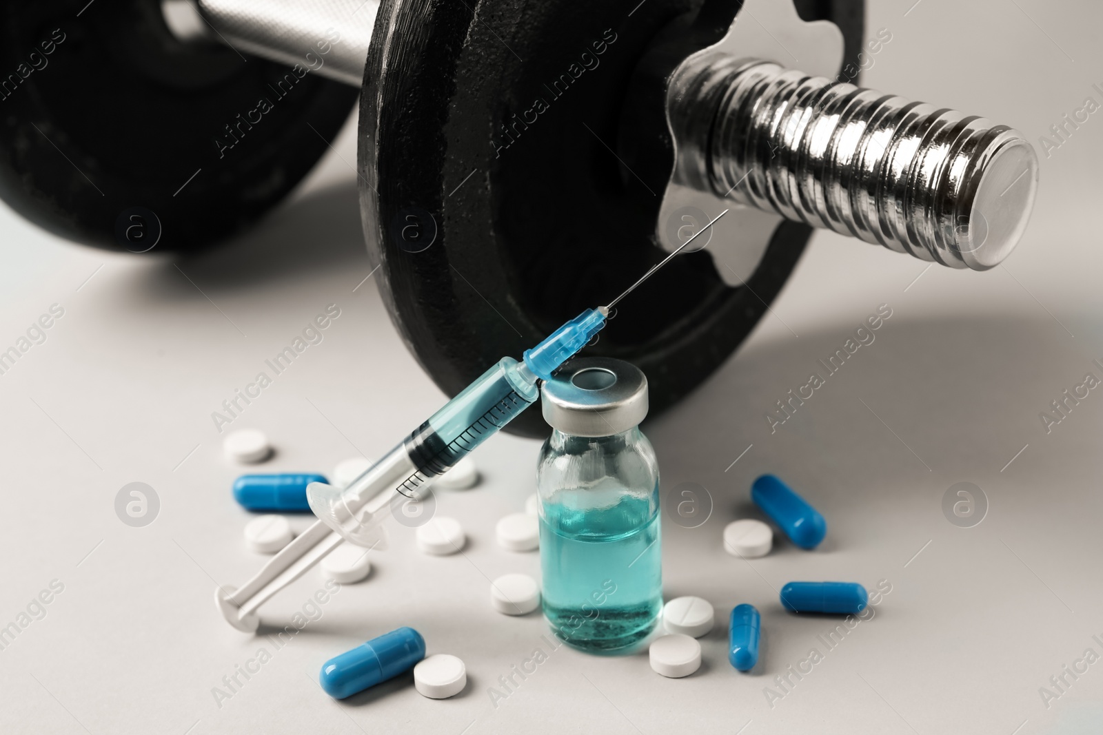 Photo of Different drugs and sports equipment on grey background. Doping control