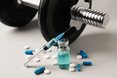 Different drugs and sports equipment on grey background. Doping control