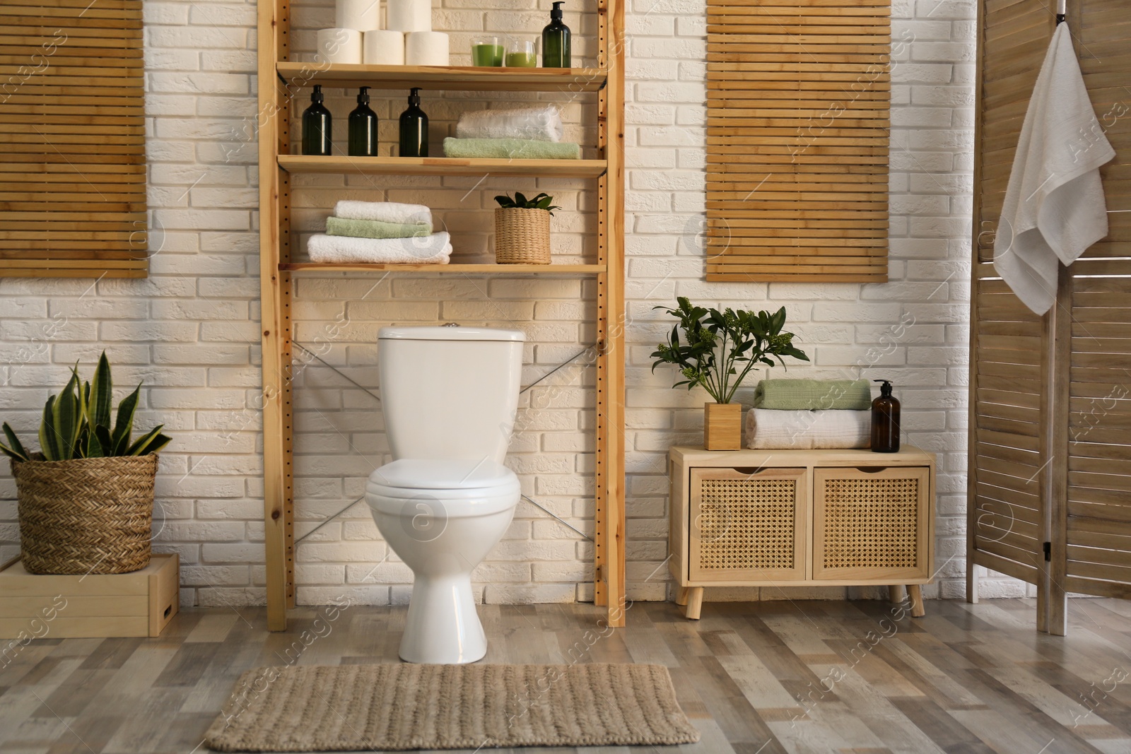 Photo of Stylish bathroom interior with toilet bowl and other essentials