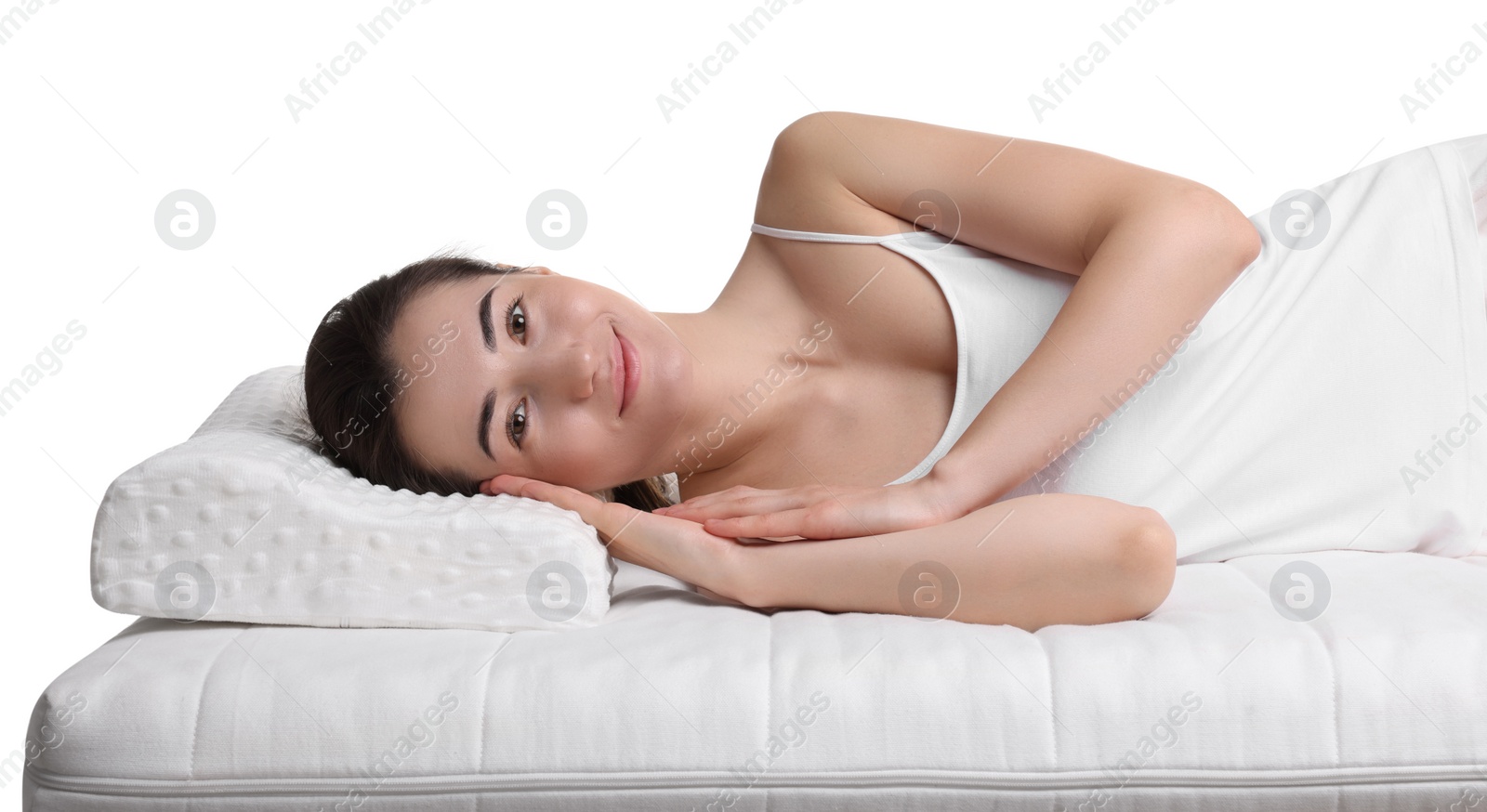 Photo of Woman lying on orthopedic pillow against white background