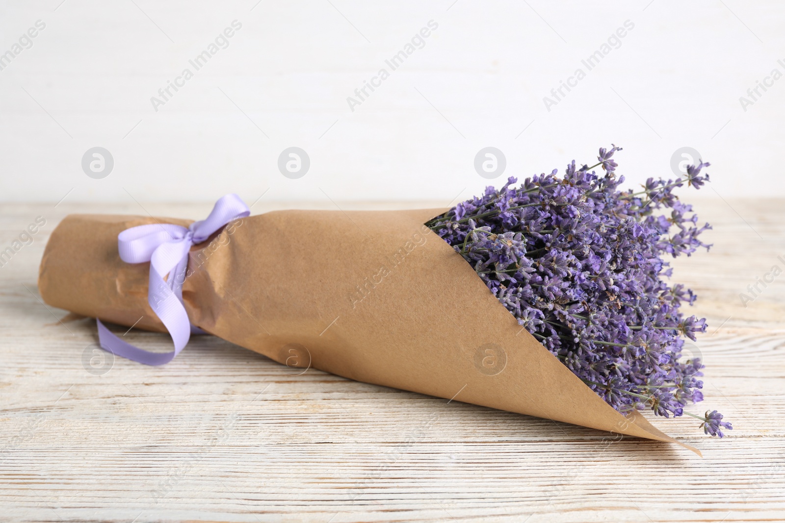 Photo of Beautiful lavender bouquet on white wooden table