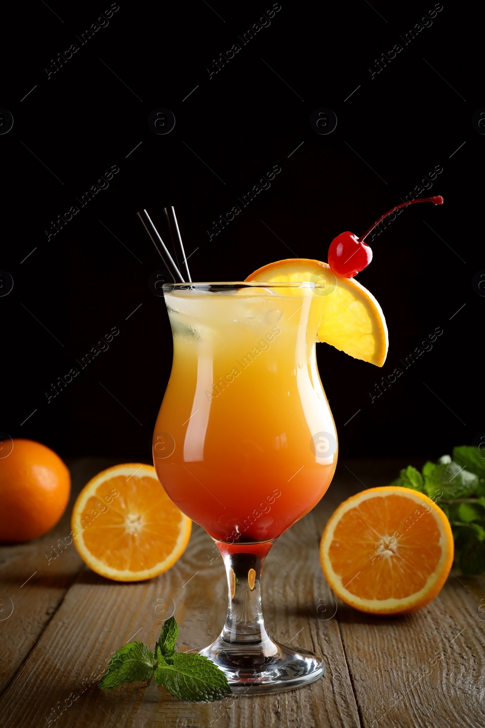 Photo of Just made appetizing cocktail Sex on the Beach, black background