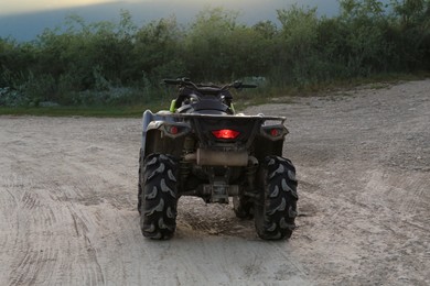 Photo of Modern fast quad bike on pathway outdoors