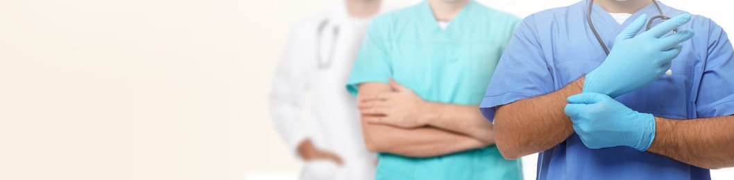 Image of Doctors and nurse on light background, closeup. Banner design with space for text