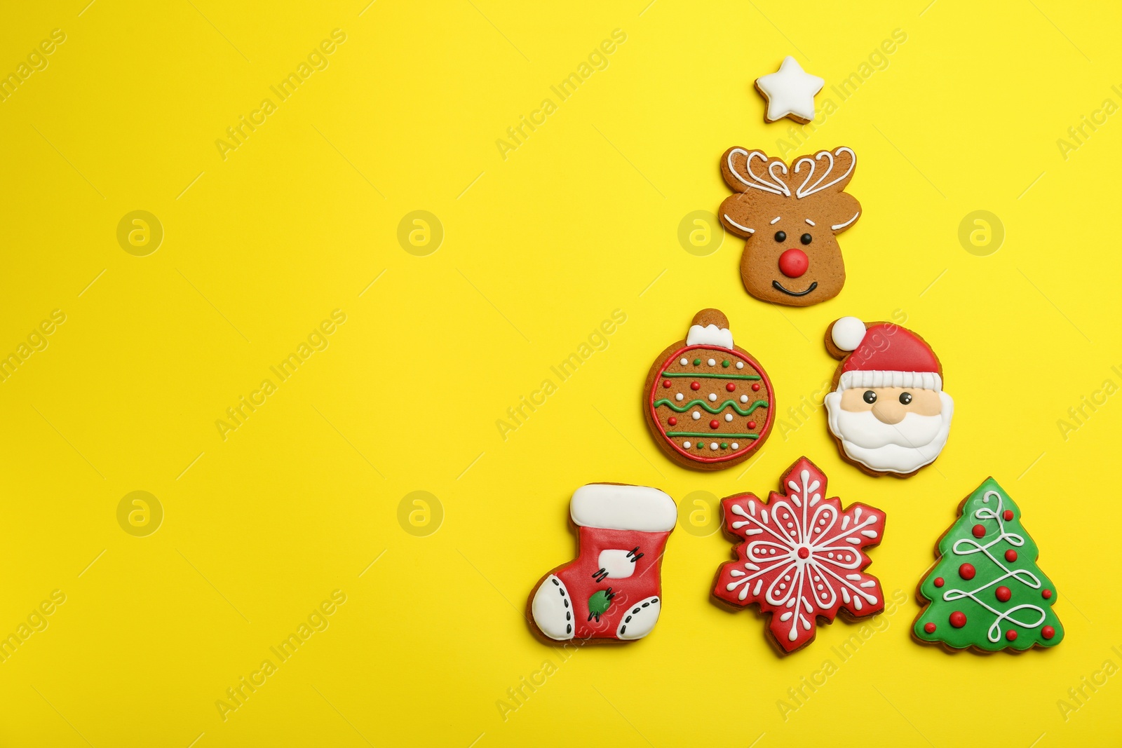 Photo of Different tasty Christmas cookies on yellow background, flat lay. Space for text