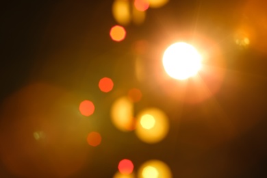 Blurred view of beautiful lights on dark background. Bokeh effect