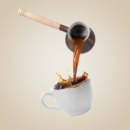 Pouring freshly brewed aromatic coffee from turkish pot into cup. Objects in air on beige background