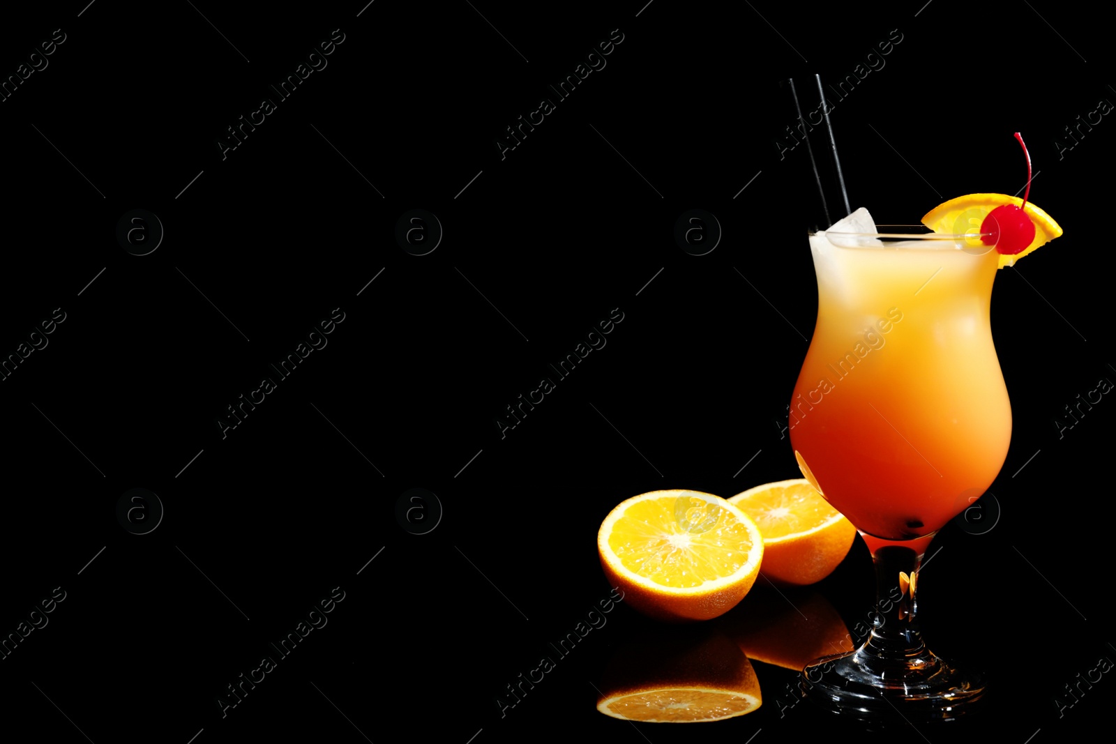 Photo of Just made appetizing cocktail Sex on the Beach, black background. Space for text