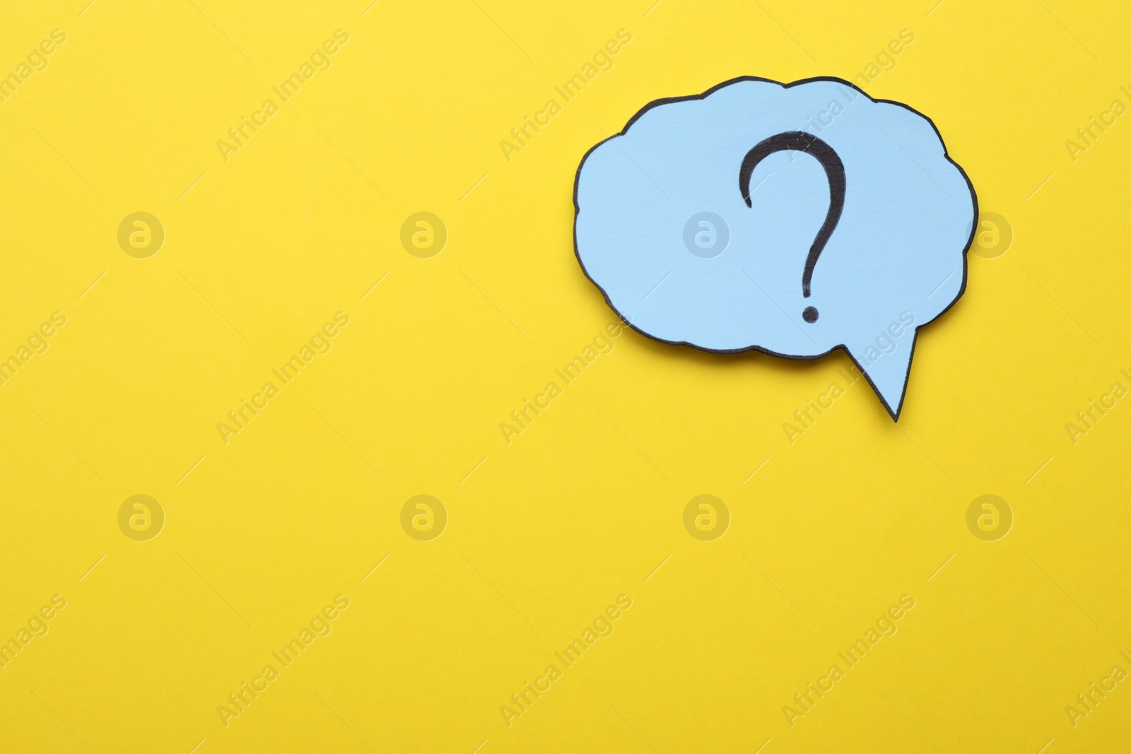 Photo of Paper speech bubble with question mark on yellow background, top view. Space for text