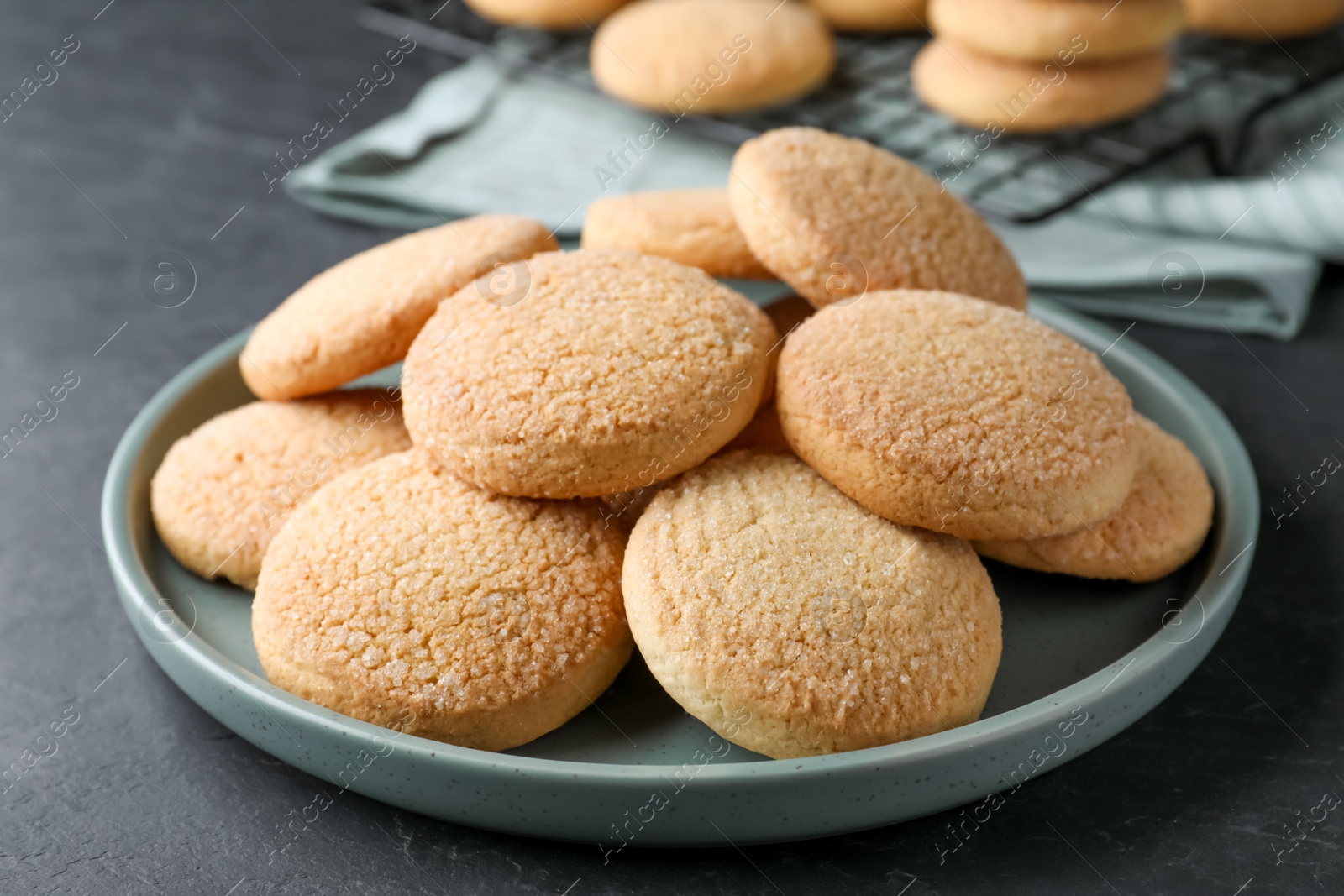 Photo of Delicious sugar cookies on black table, closeup