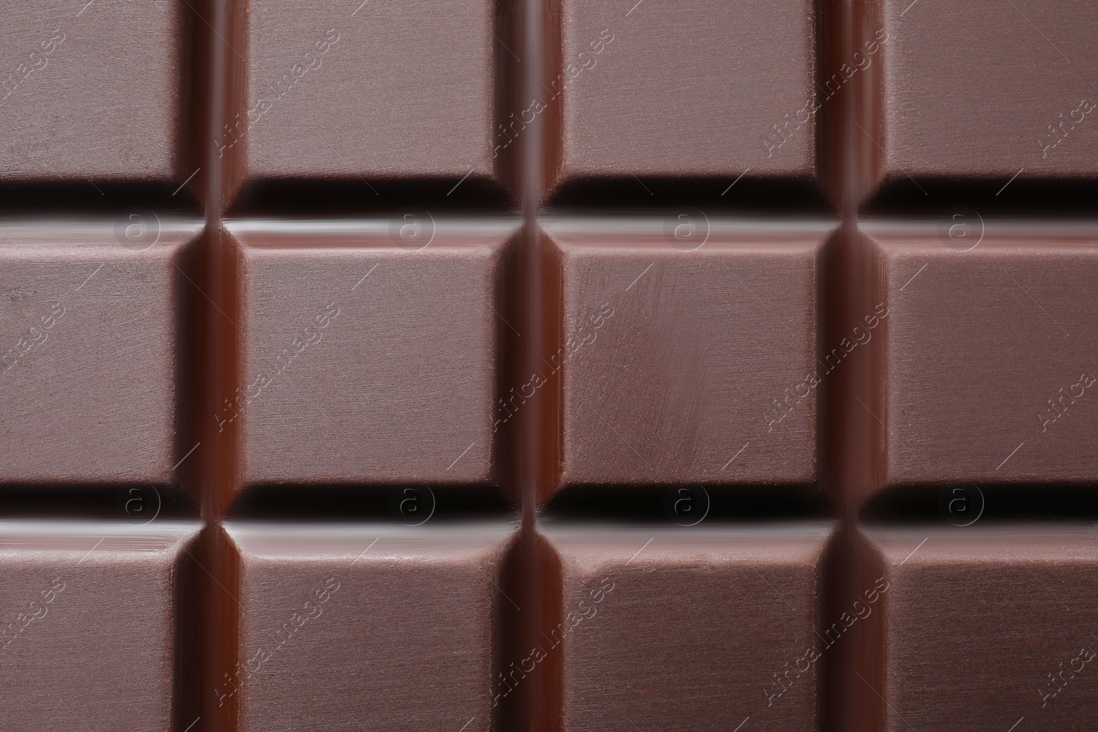 Photo of Delicious dark chocolate bar as background, top view