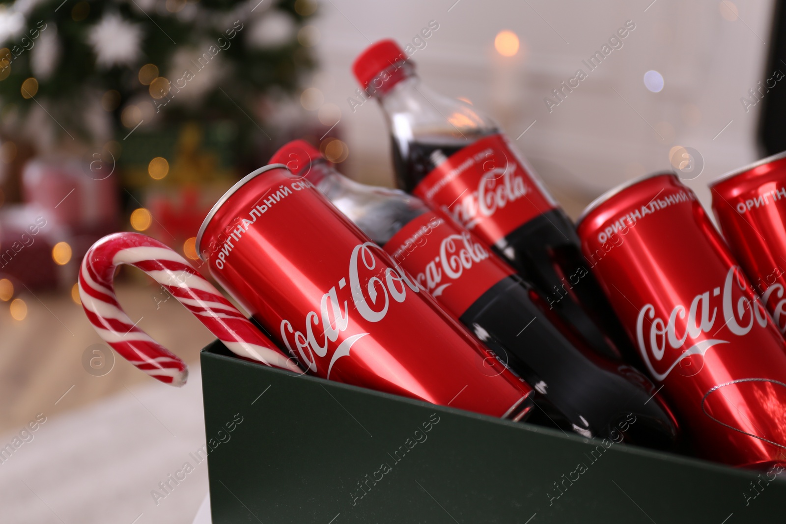 Photo of MYKOLAIV, UKRAINE - JANUARY 13, 2021: Coca-Cola bottles and cans in box, closeup