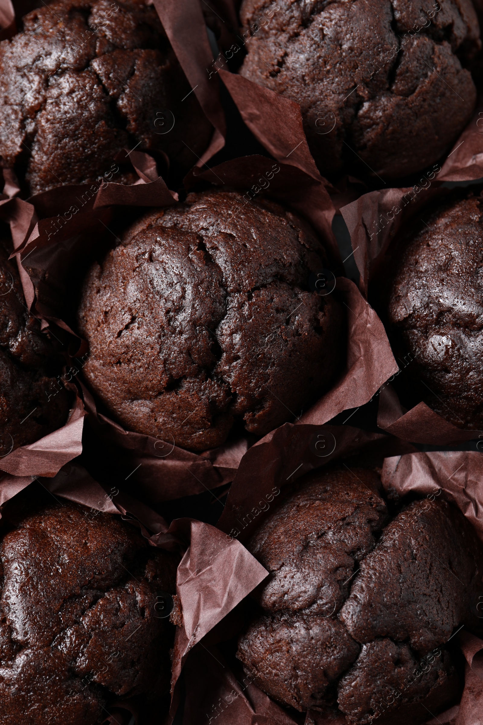 Photo of Tasty chocolate muffins as background, top view