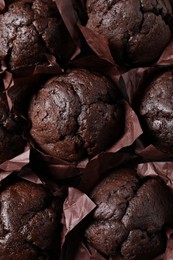 Photo of Tasty chocolate muffins as background, top view